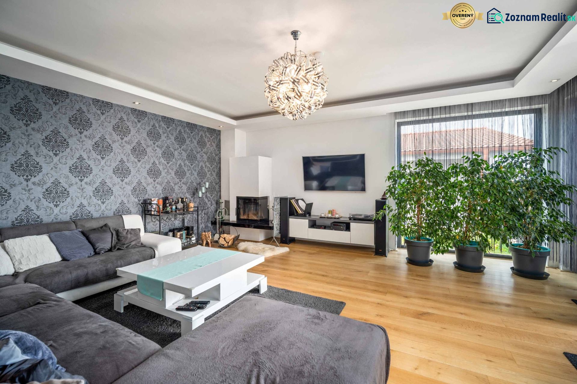 Living room of a family house with wallpaper and wooden decor flooring.