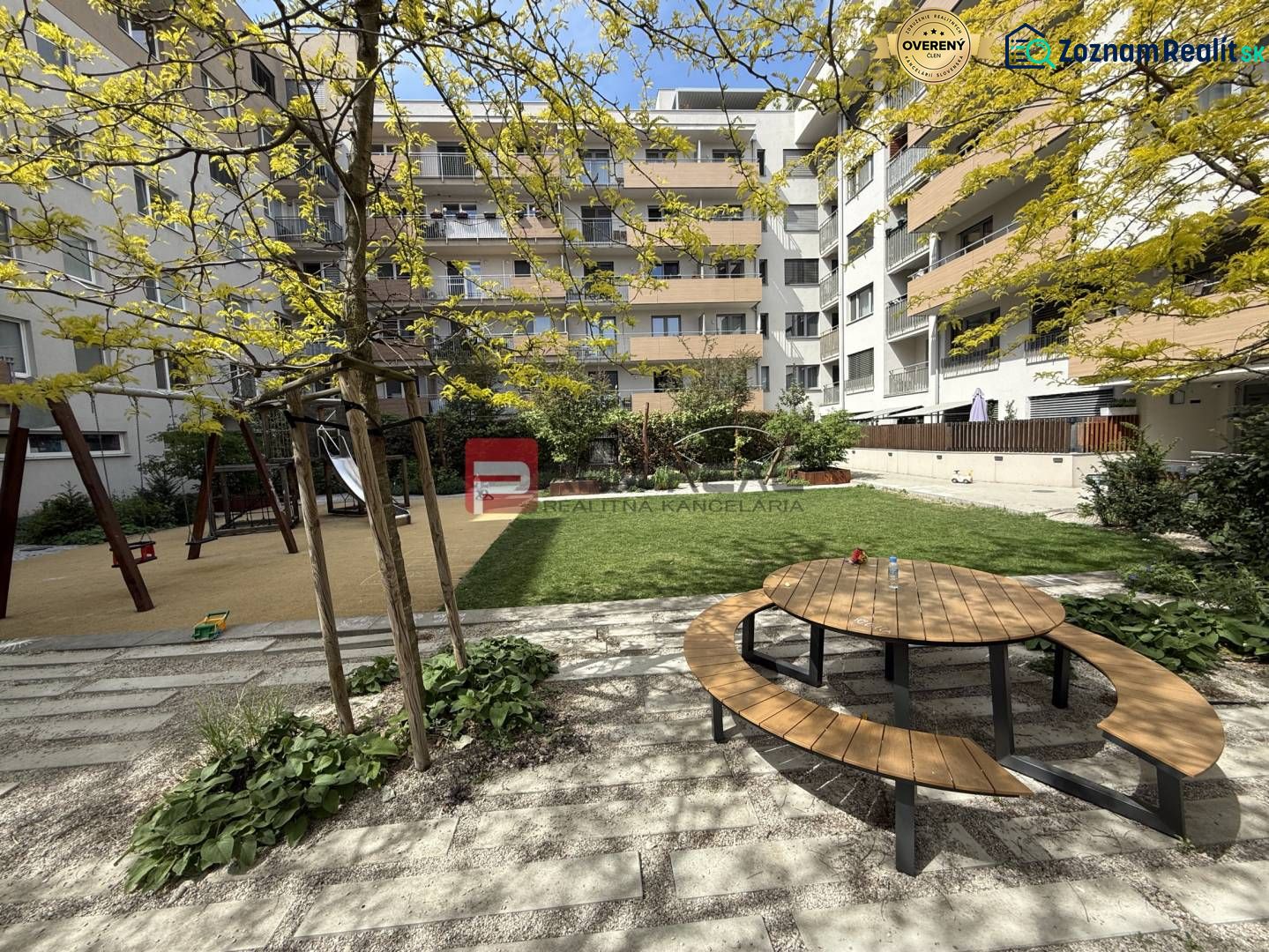 Playground and bench in the garden of the apartment complex on Galvaniho Street in Bratislava II.