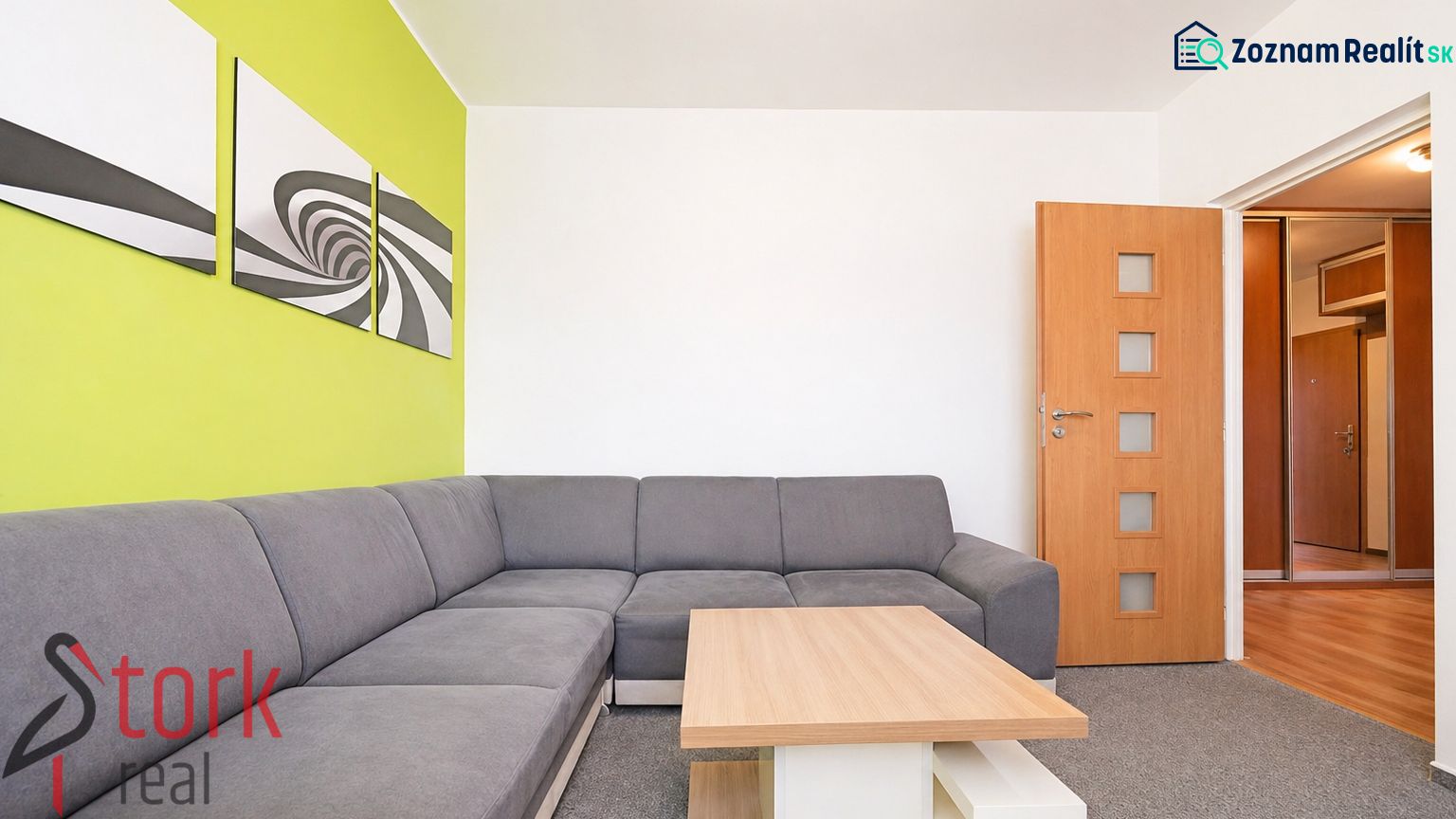 Living room with a corner sofa and a green wall in a 3-room apartment.