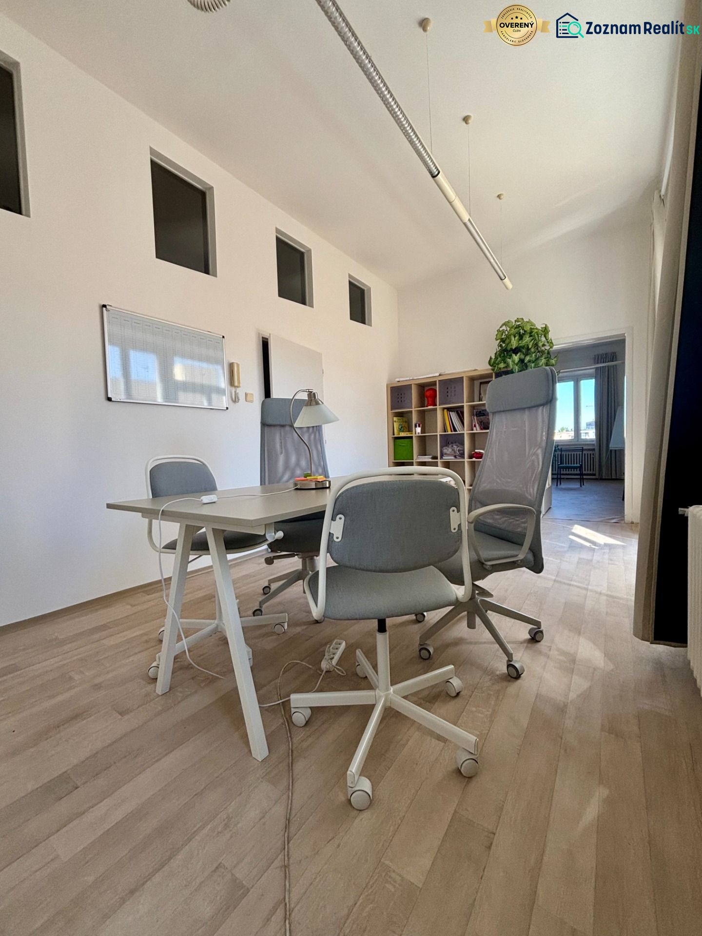 Offices with wood-patterned flooring, white walls, and seating.