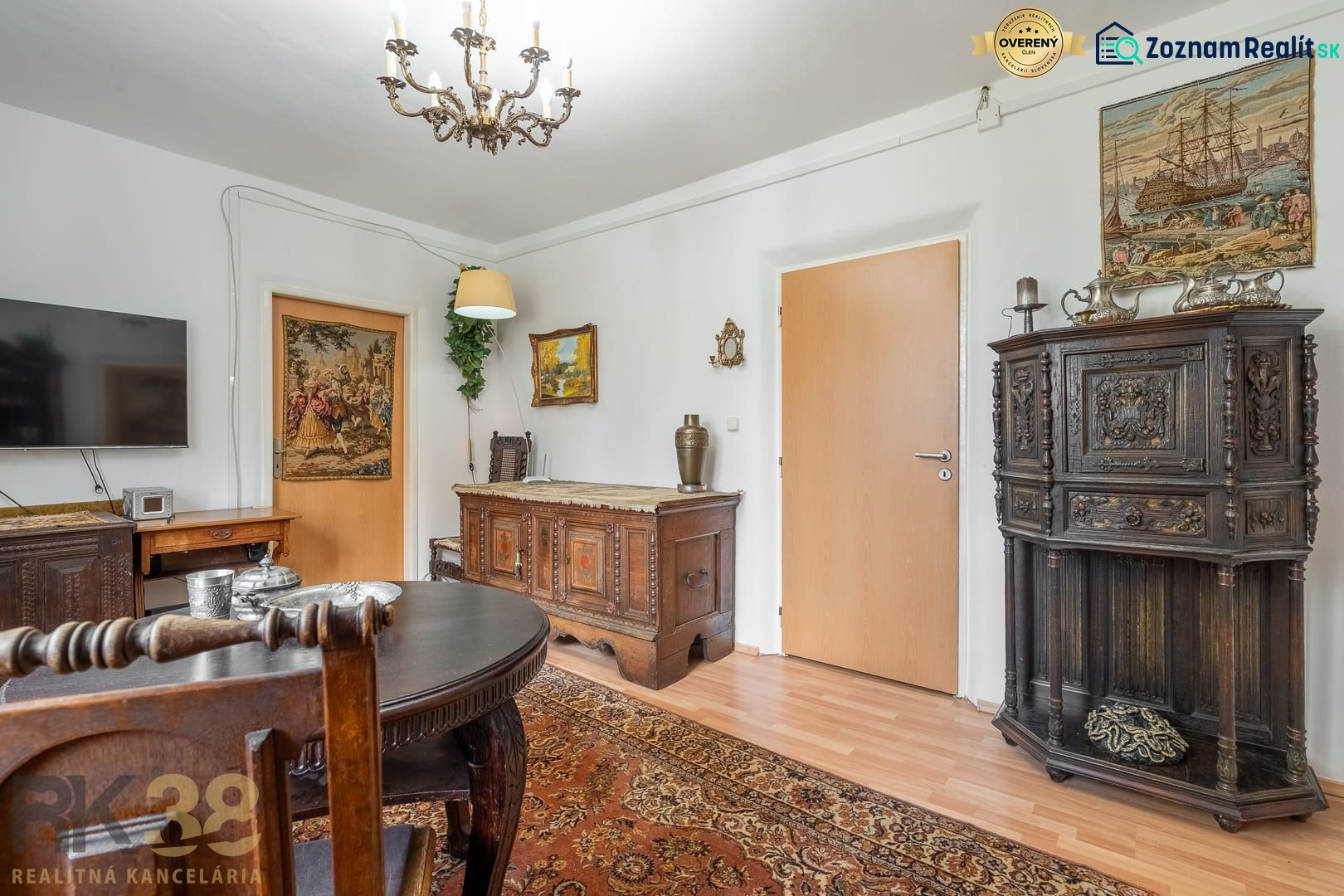 Living room with antique furniture and wood-patterned flooring in a 4-room apartment.