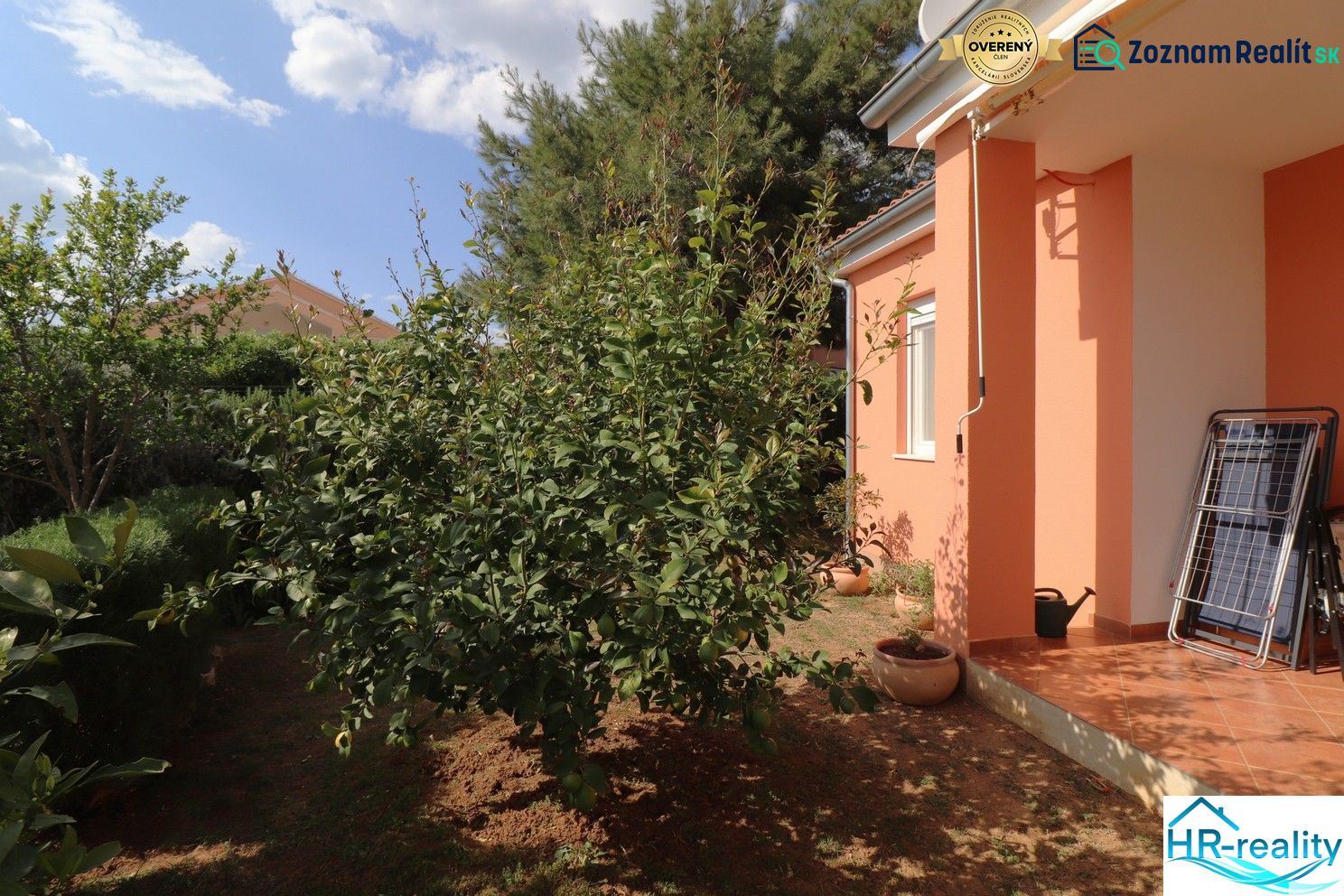 A family house in Vodice with an orange facade and a landscaped garden.