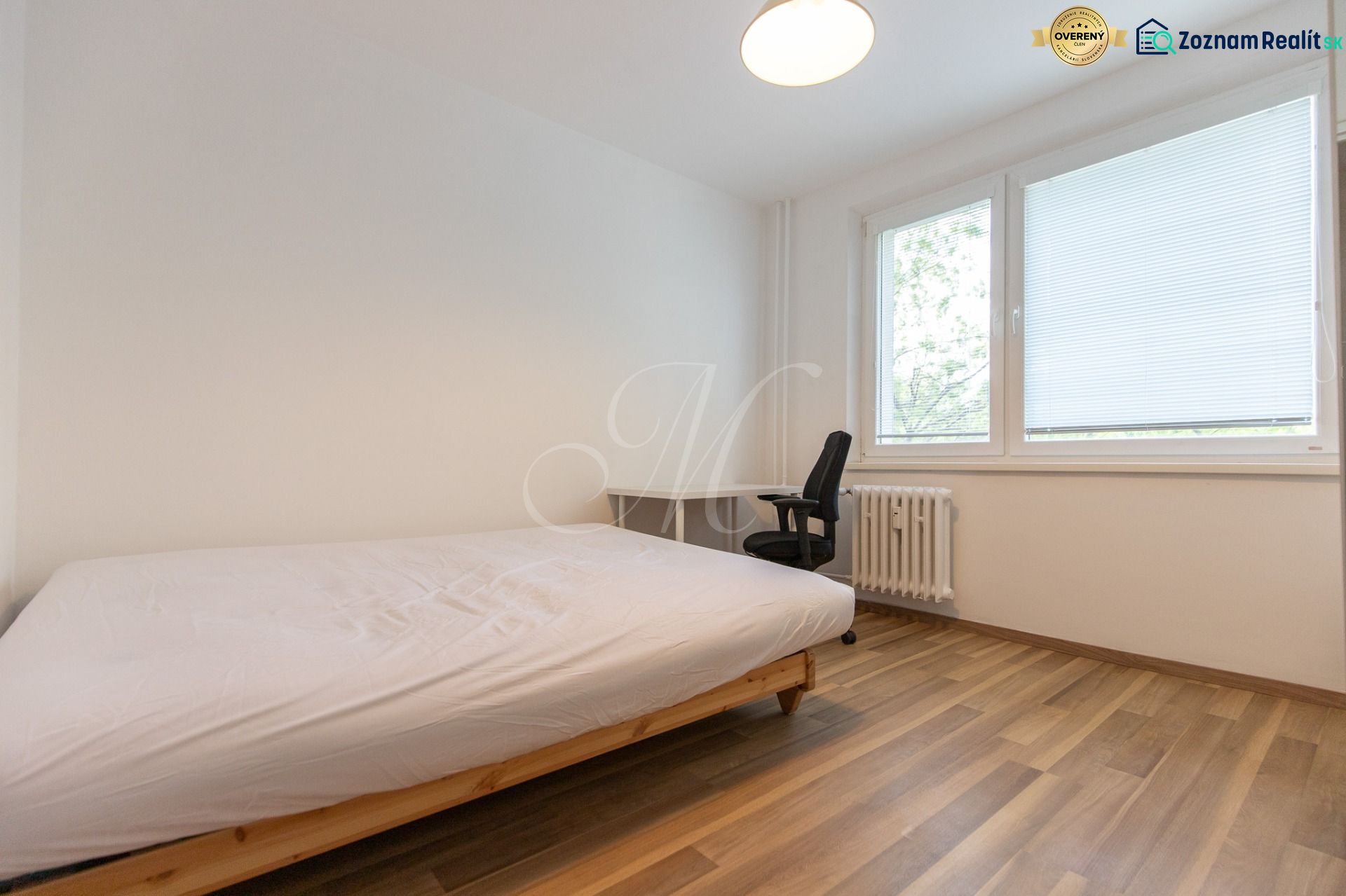 A bedroom with a single bed, a desk, and a wooden decor floor in a 3-room apartment.