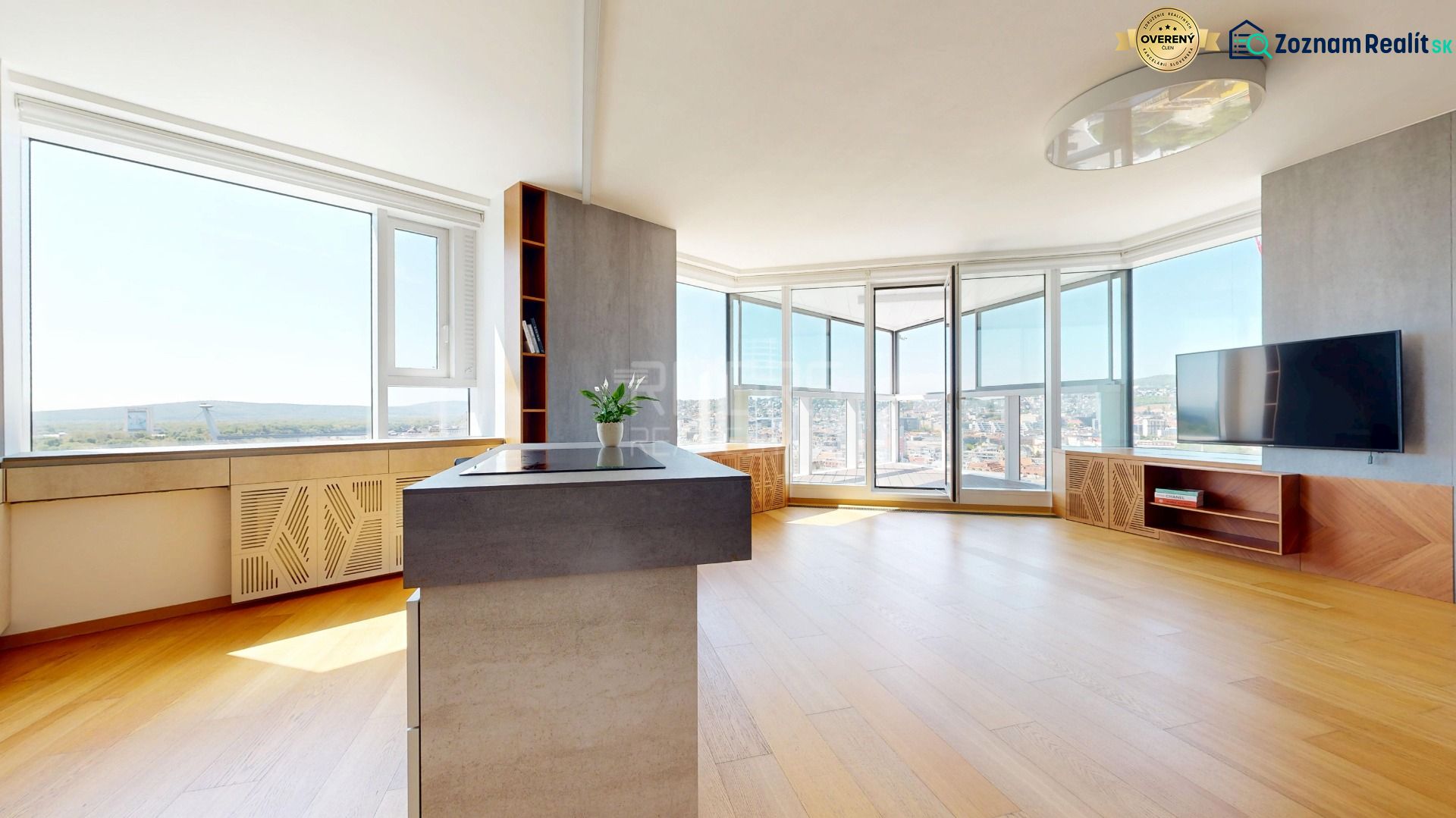 A spacious living area with a view and wood-decor flooring in a 4-room apartment.