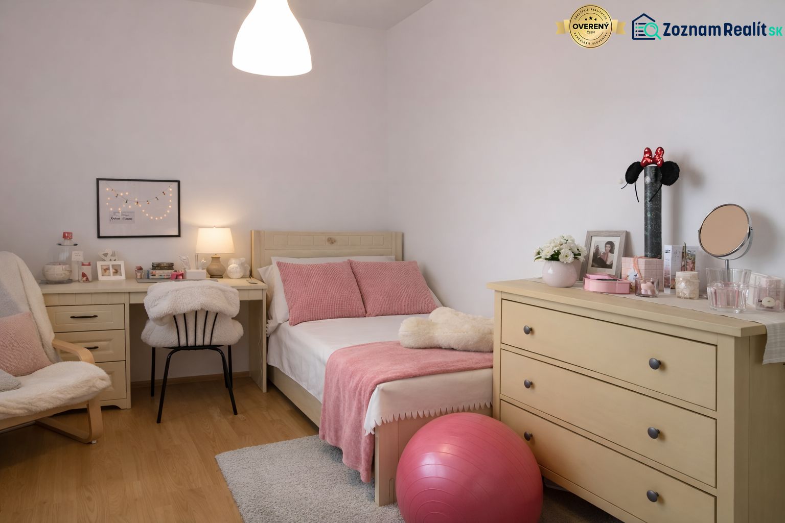 A room in a 4-room apartment with a bed, dresser, desk, and decorations.