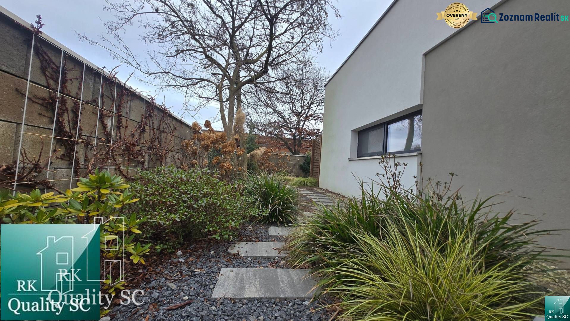 A family house in Senec with a landscaped garden path, decorated with pebbles and green plants.