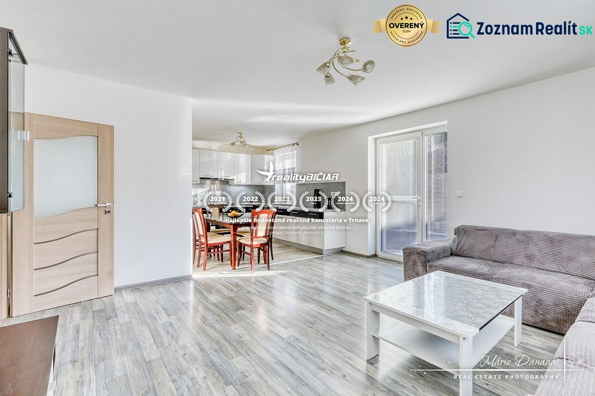 Interior of a family house with an open kitchen and living room, floor with wooden decor.