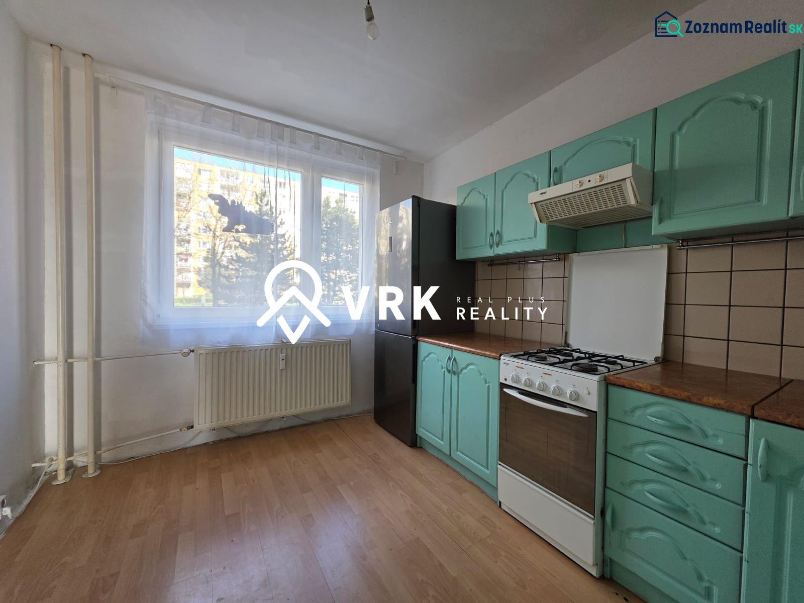A kitchen with a gas stove, green cabinets, and a wood-patterned floor in a 4-room apartment.