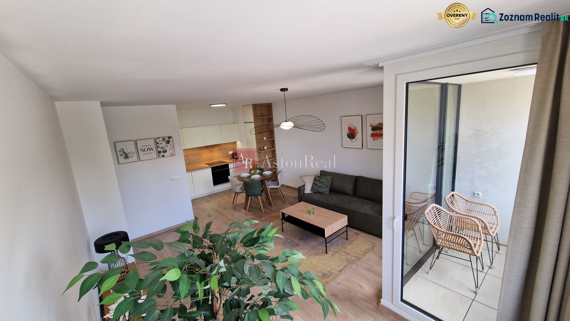 Interior of a 2-room apartment with a wood-decor floor, modern furniture, and a balcony.