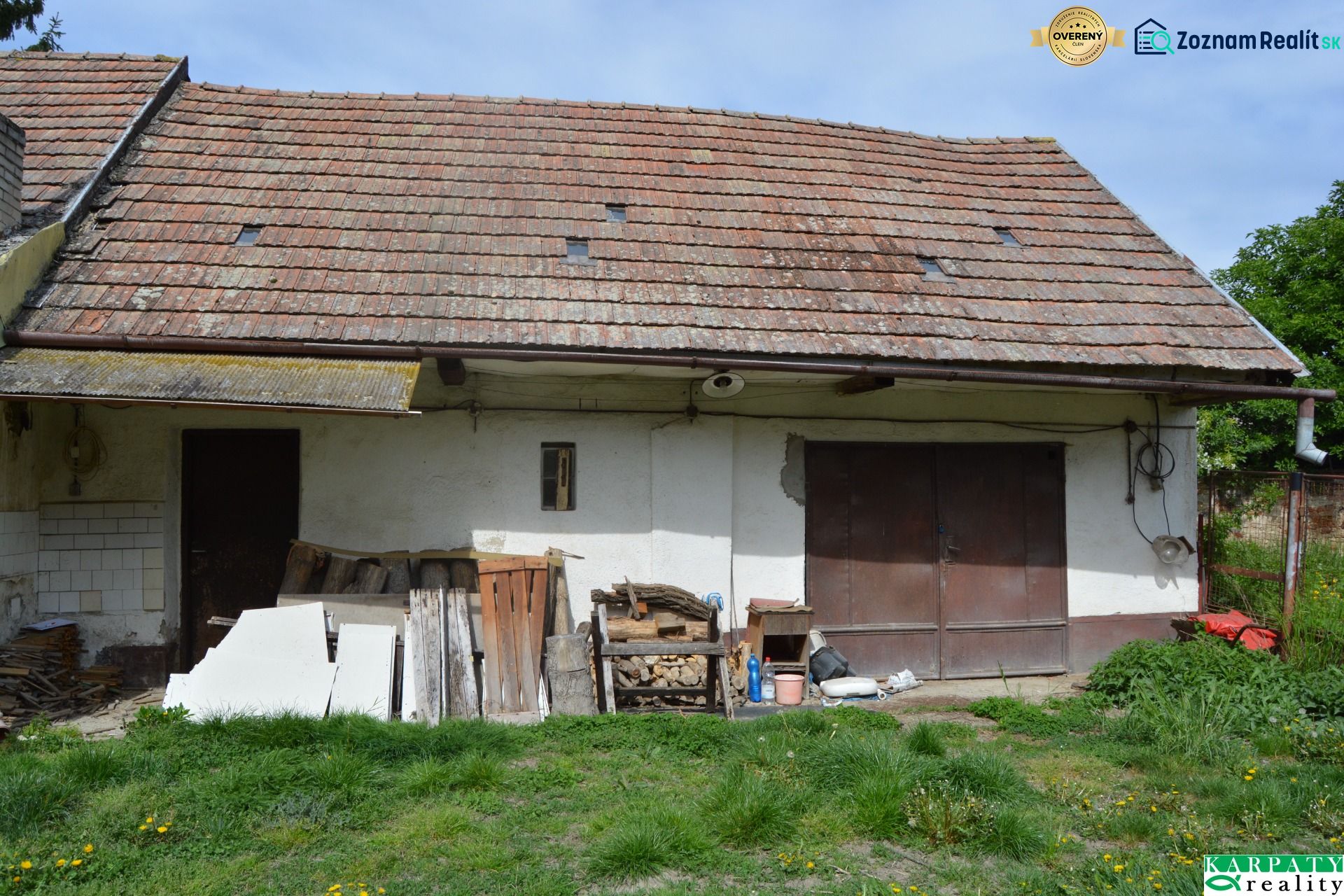 A family house in Horné Saliby with an old roof and an unmaintained exterior space.