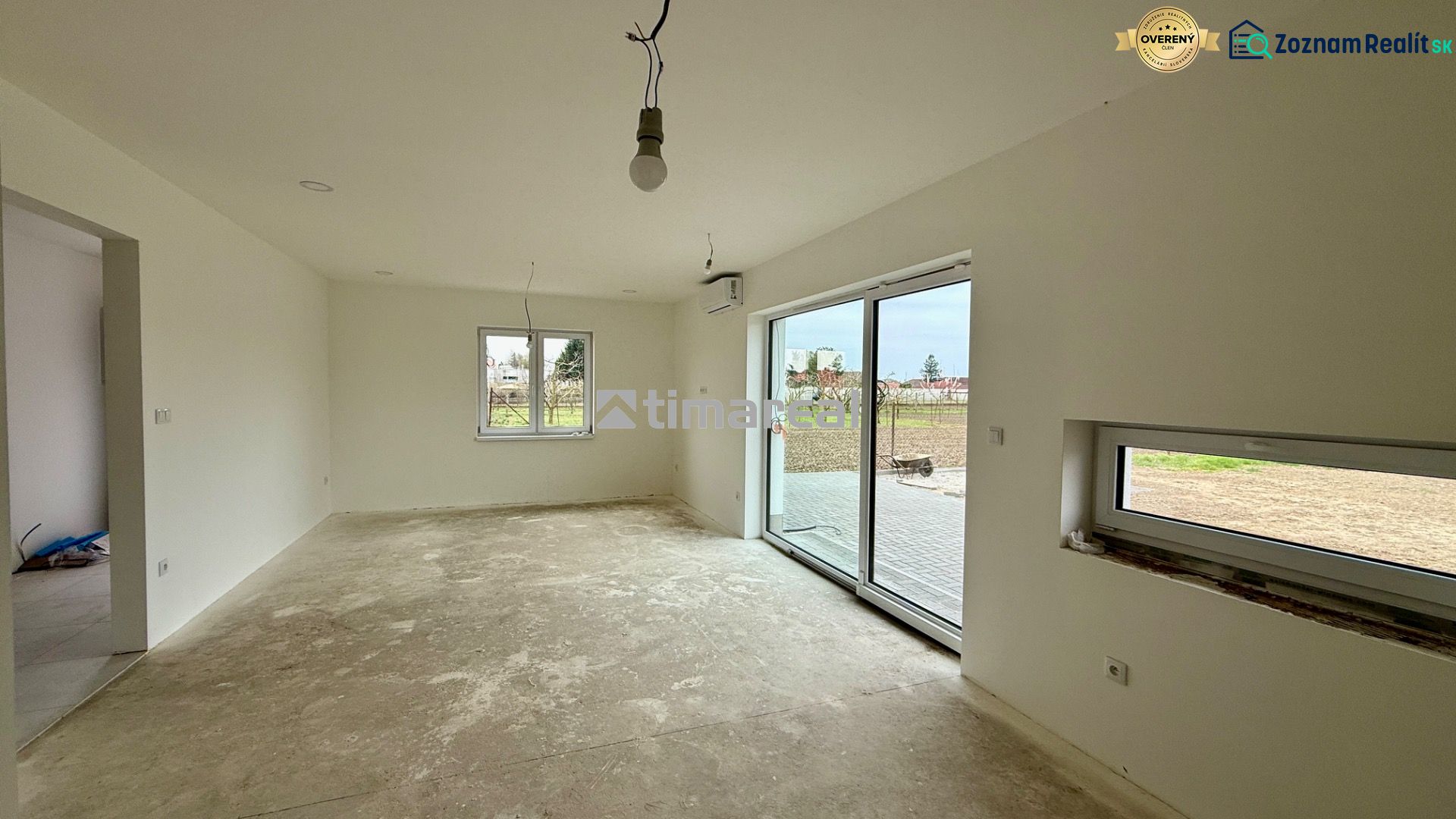The family house has a spacious room with white walls and sliding doors.