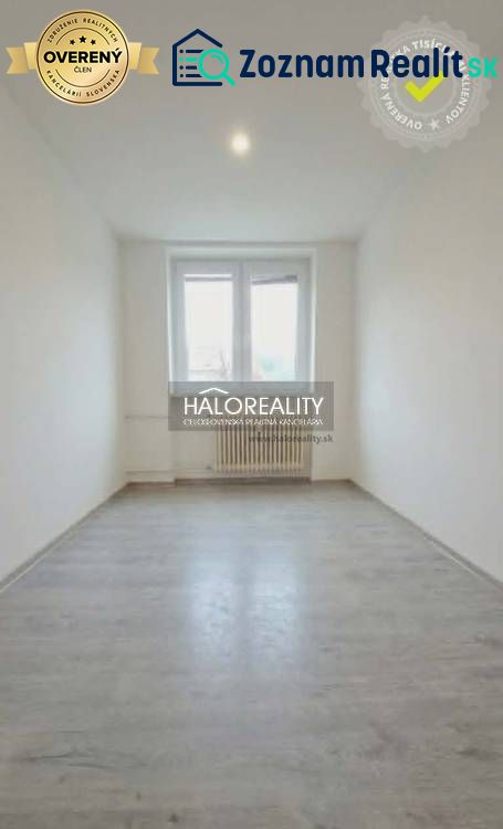 A room in a 3-room apartment with a wooden-patterned floor and white walls.