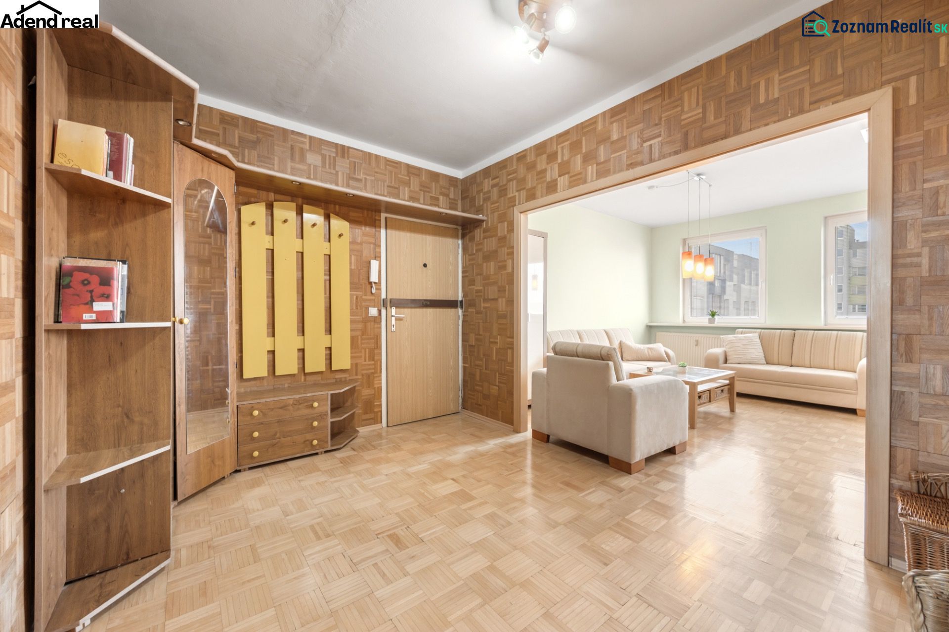 A hallway with wooden decor and entrance to the living room in a 3-room apartment.