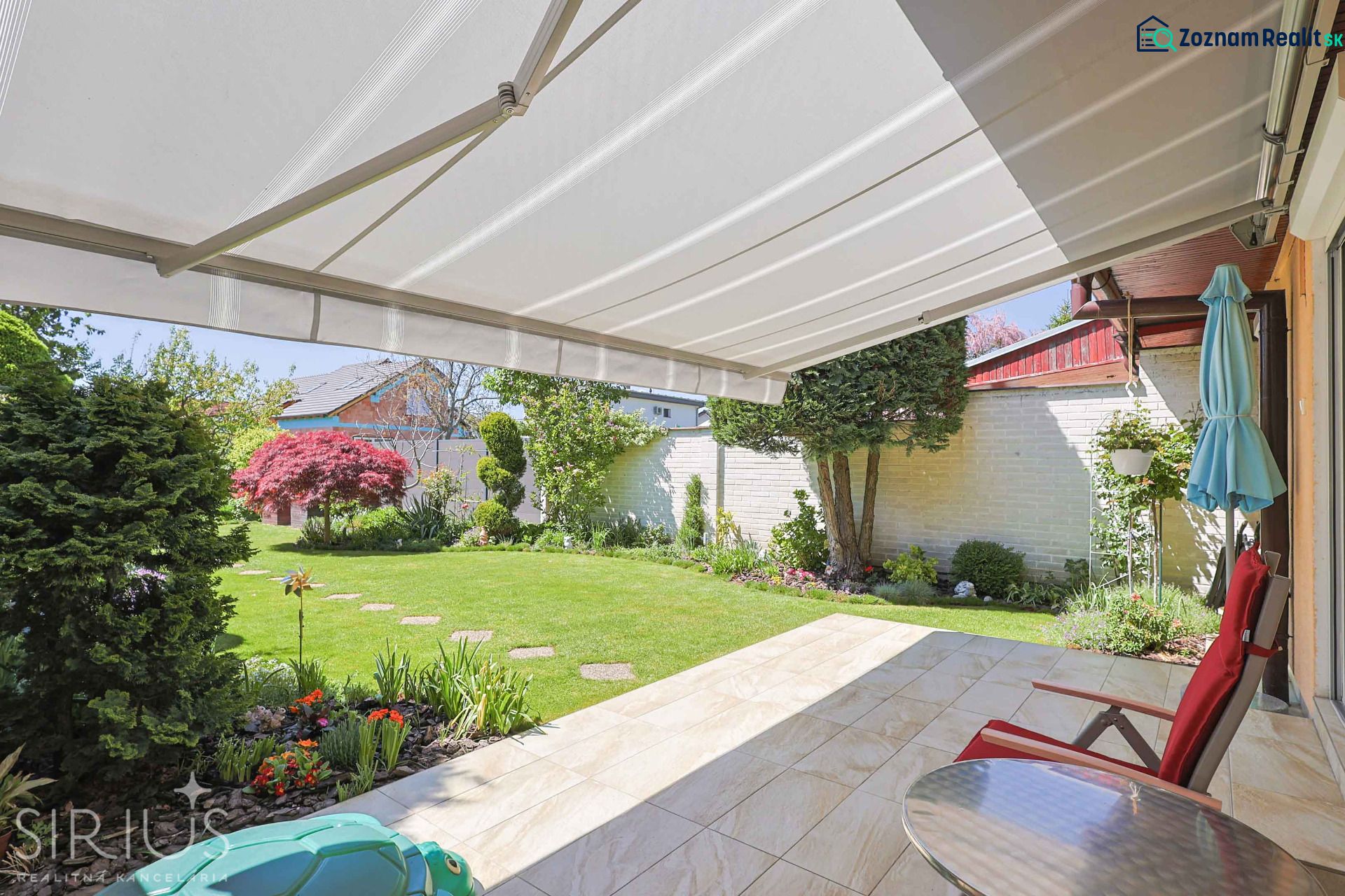 Terrace of a family house on Hollého Street in Stupava with a garden and an awning.