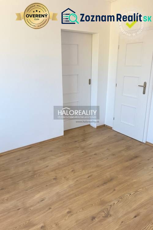 Interior of a family house with white doors and a floor with a wood decor.