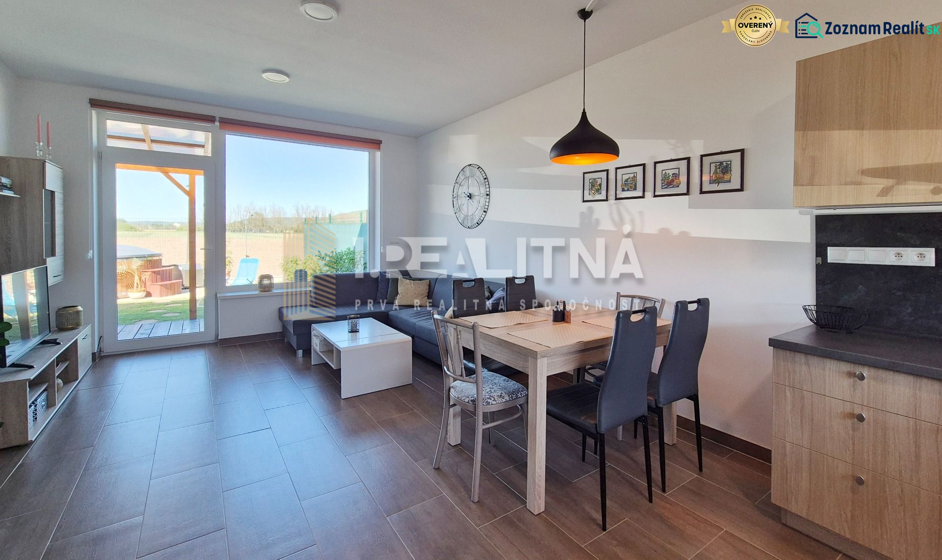 Dining room in a family house with a wooden decor floor and an outdoor view.