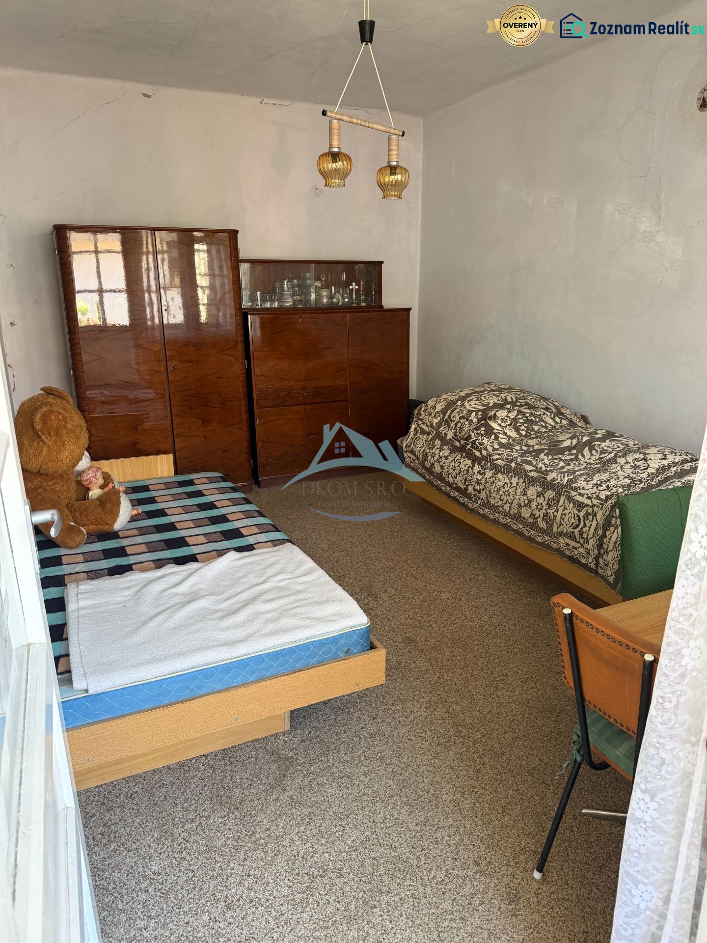 A room with two beds and a cabinet in a family house.