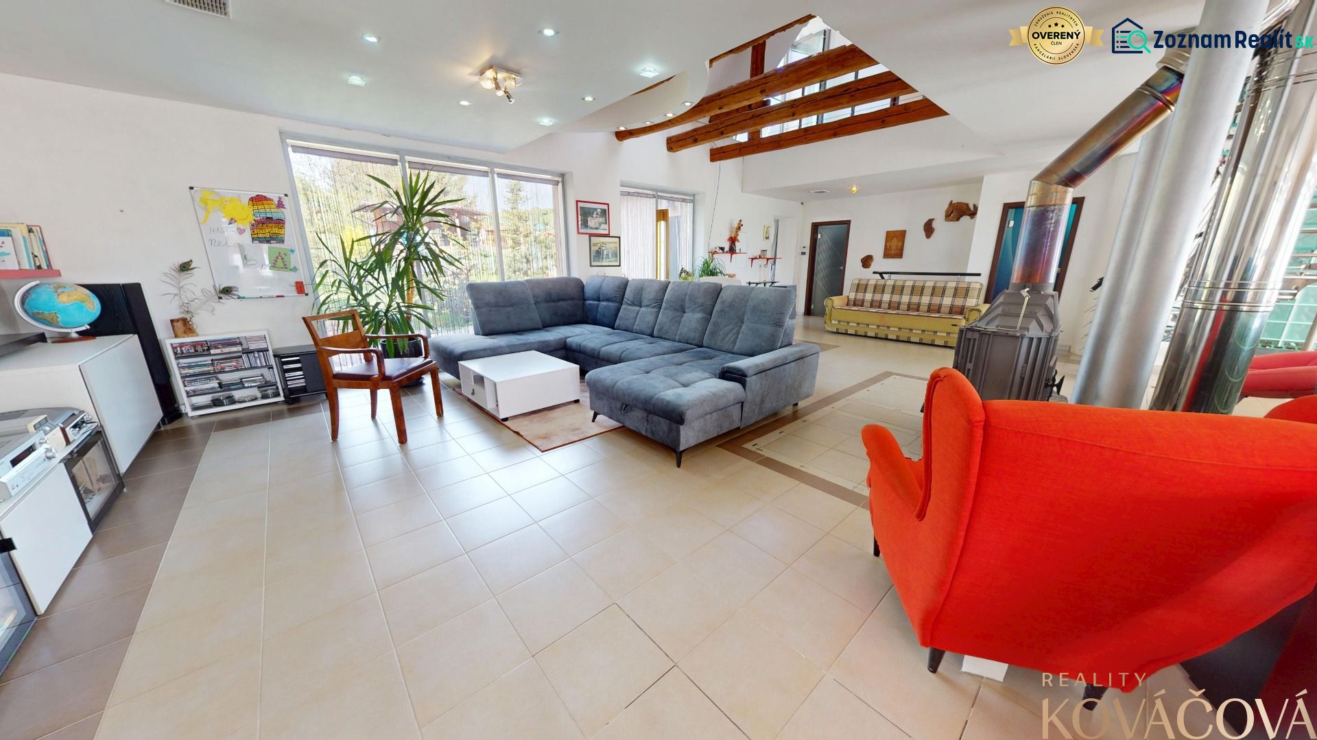 Living room in a family house with a fireplace, sofa, and houseplants.