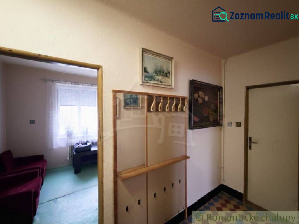 A hallway in a family house with a wardrobe and a view of the room.