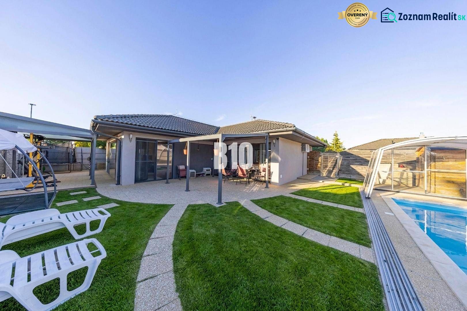 A family house in Most pri Bratislave with a terrace, a swimming pool, and sun loungers in the garden.