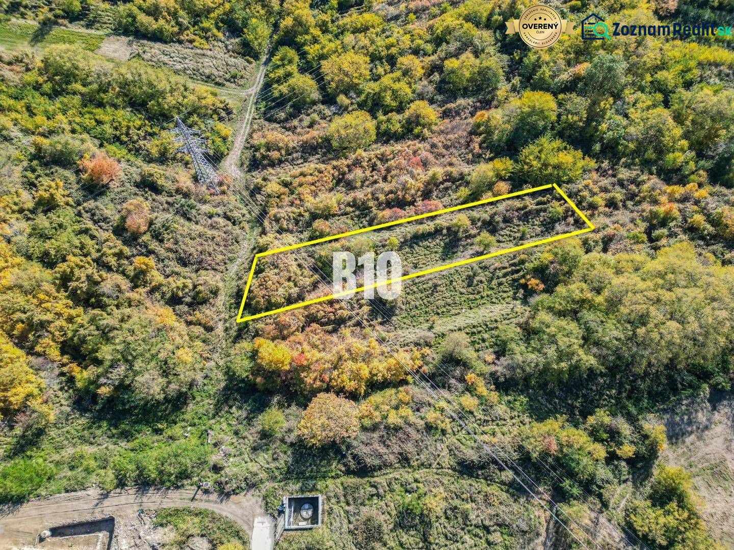 Aerial view of a plot in the Gardens of Bratislava III surrounded by wooded landscape.