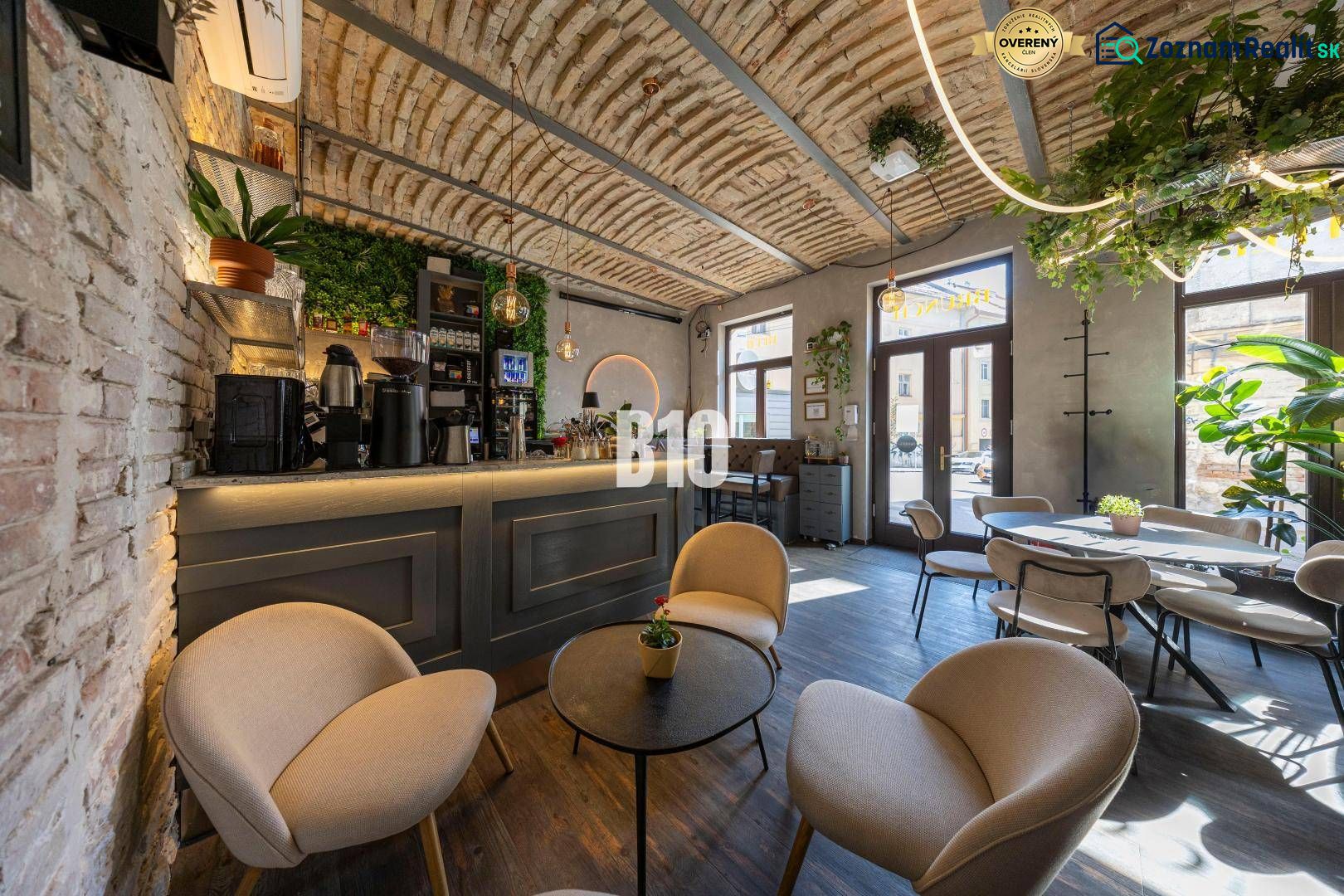 Interior gastro spaces with a bar and seating, wooden decor flooring, and plants.