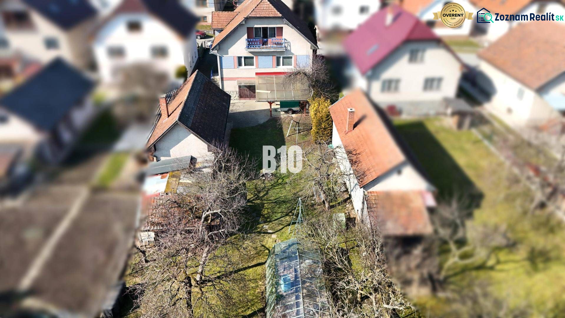 A family house in Turany with a yard, garden, and surrounding houses.