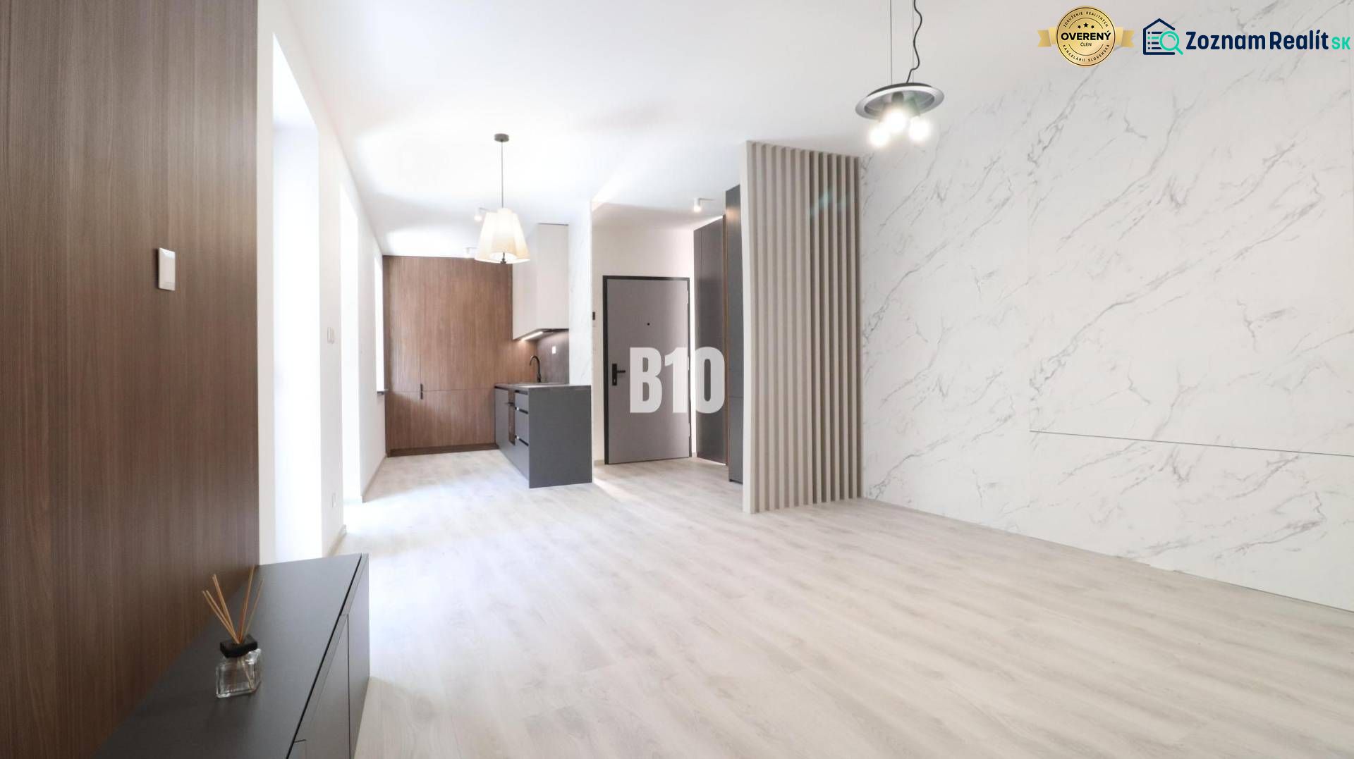 Interior of a 2-room apartment with a wooden decor floor and marble cladding.