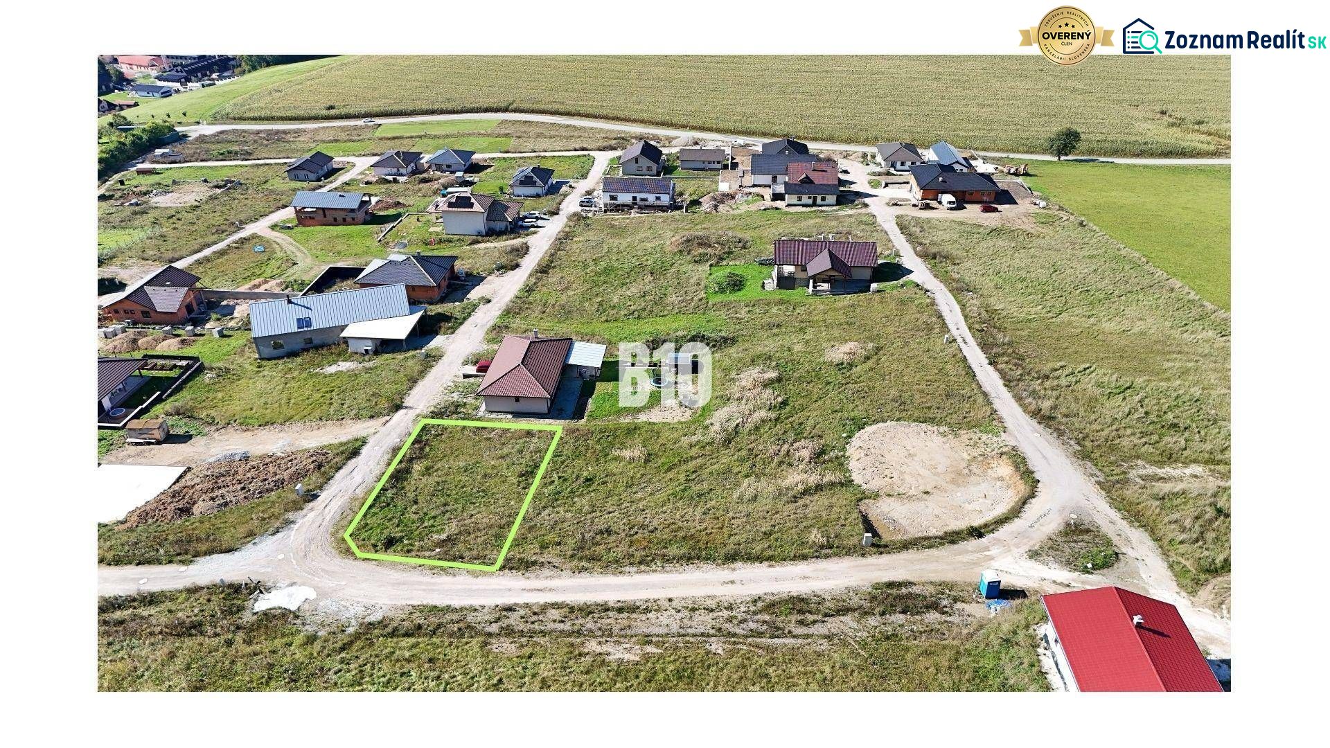 A residential plot in Necpaly, nestled among houses, ready for construction.