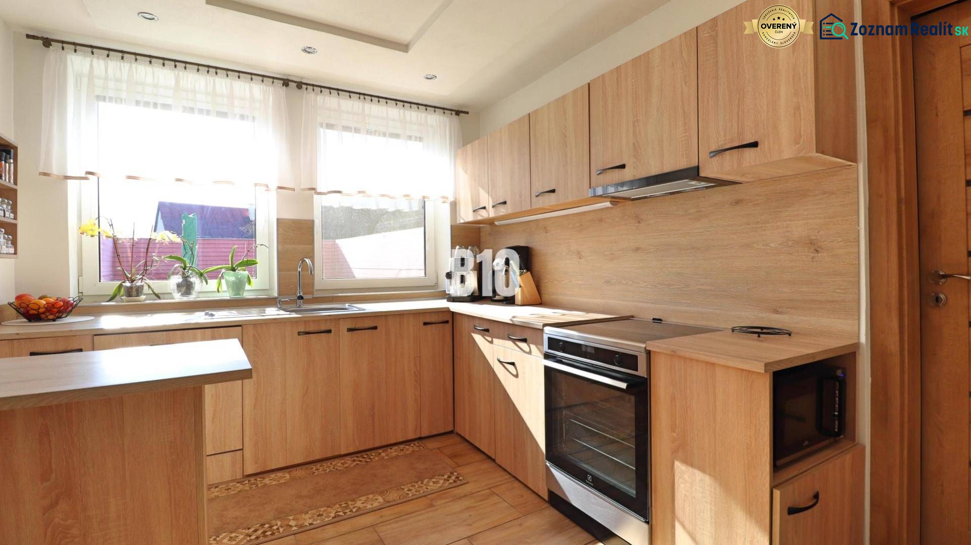 A kitchen in a family house with a wooden decor floor and furniture in light shades.