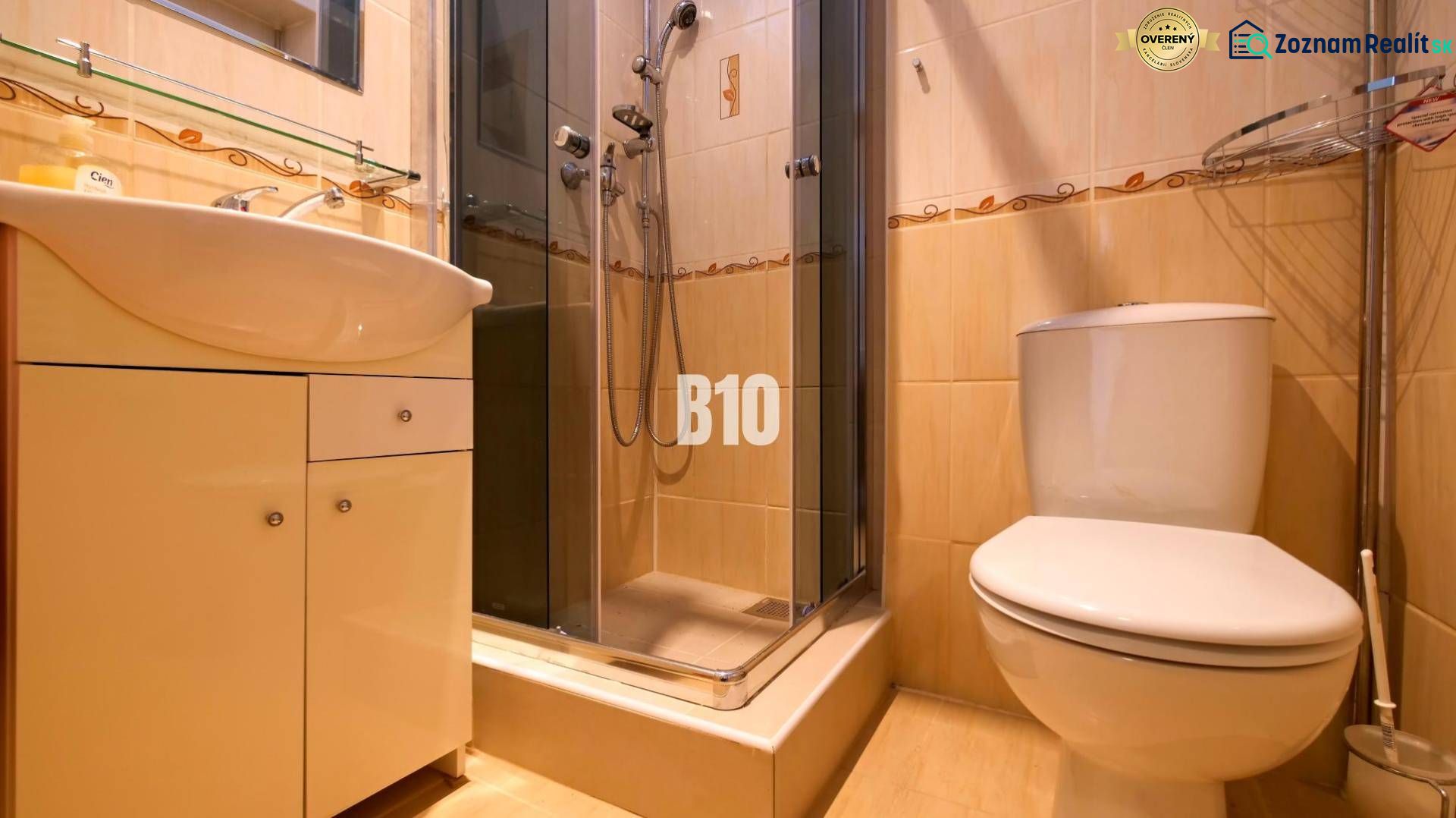 Bathroom in a studio apartment with a shower, sink, and toilet.