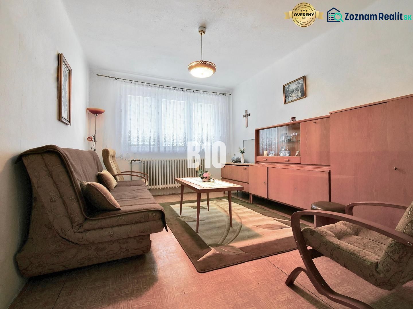 A living room in a 3-room apartment with vintage furniture and a wooden decor floor.