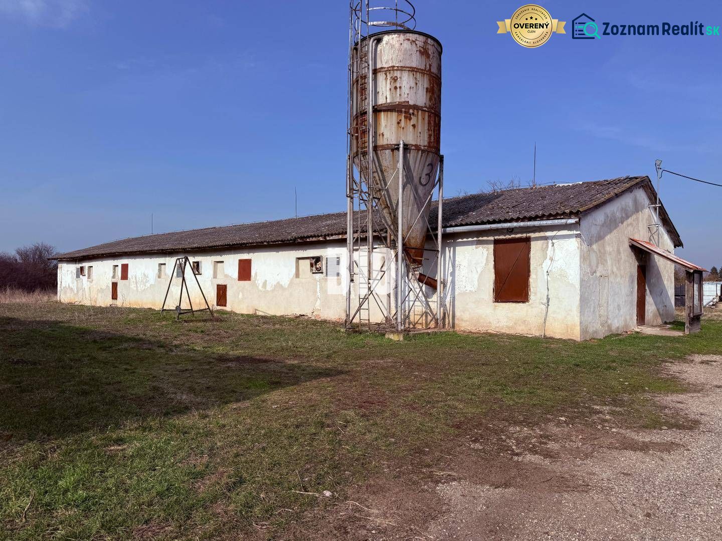 Production premises in the town of Turá with an extensive yard and older buildings in the background.