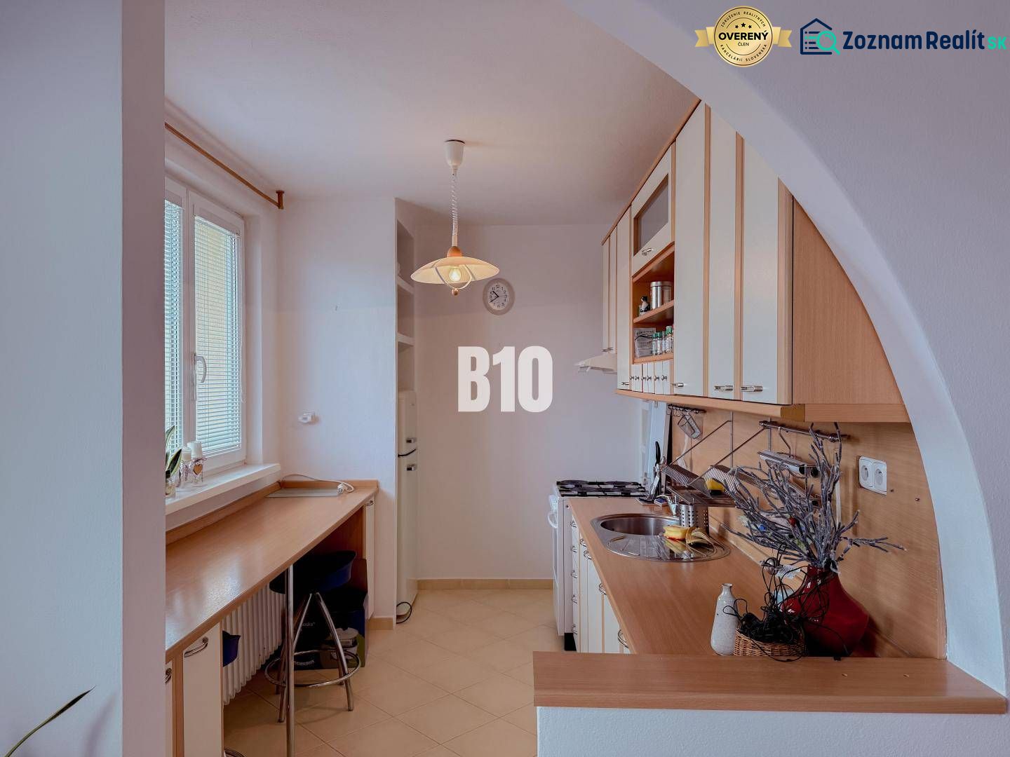 A kitchen in a 3-room apartment with a kitchenette and a bar counter.