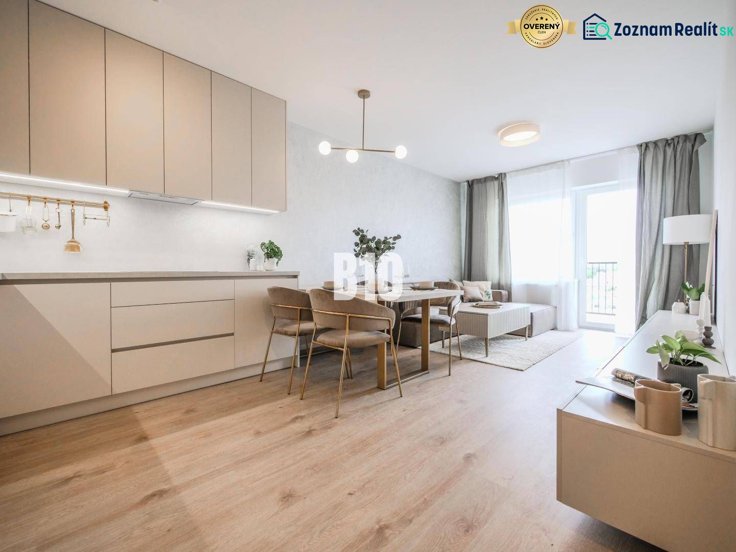 Living room connected to the kitchen in a two-room apartment with a wooden decor floor.