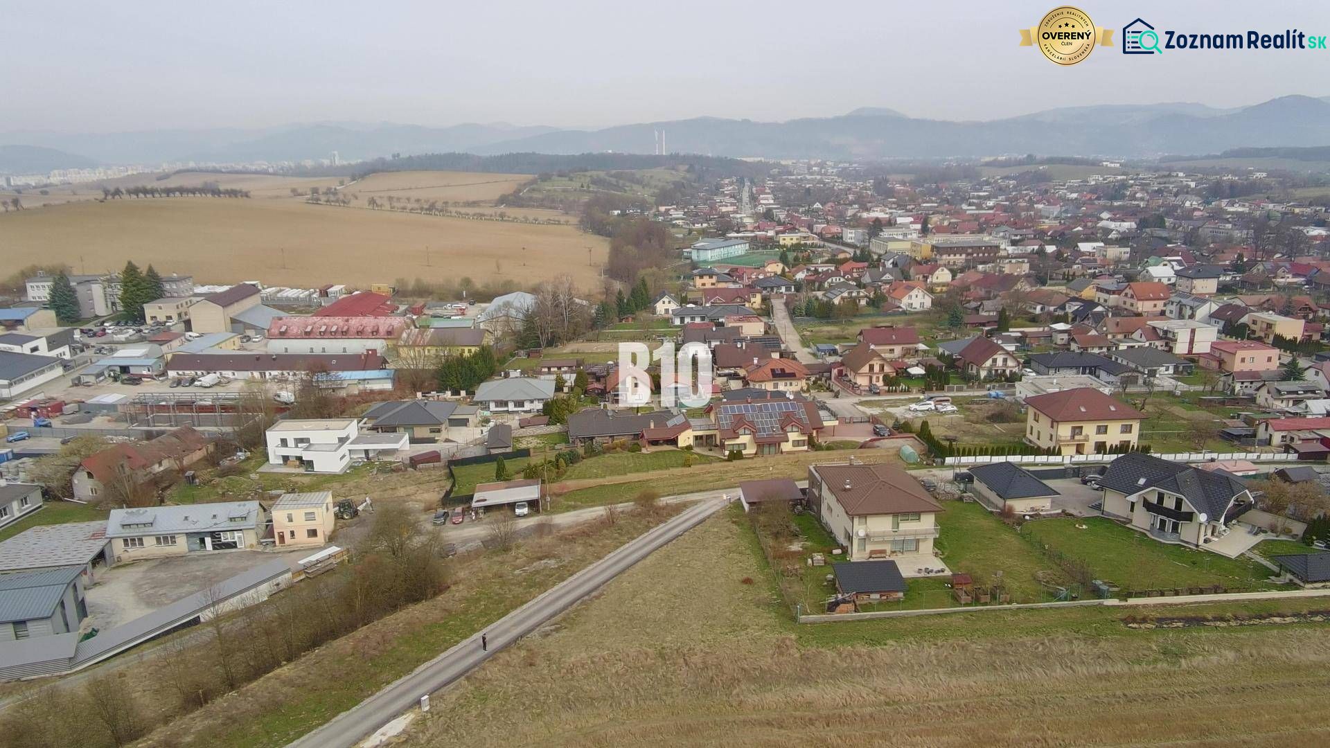 Aerial view of a residential area in Rosina with houses and greenery. Plots - housing.