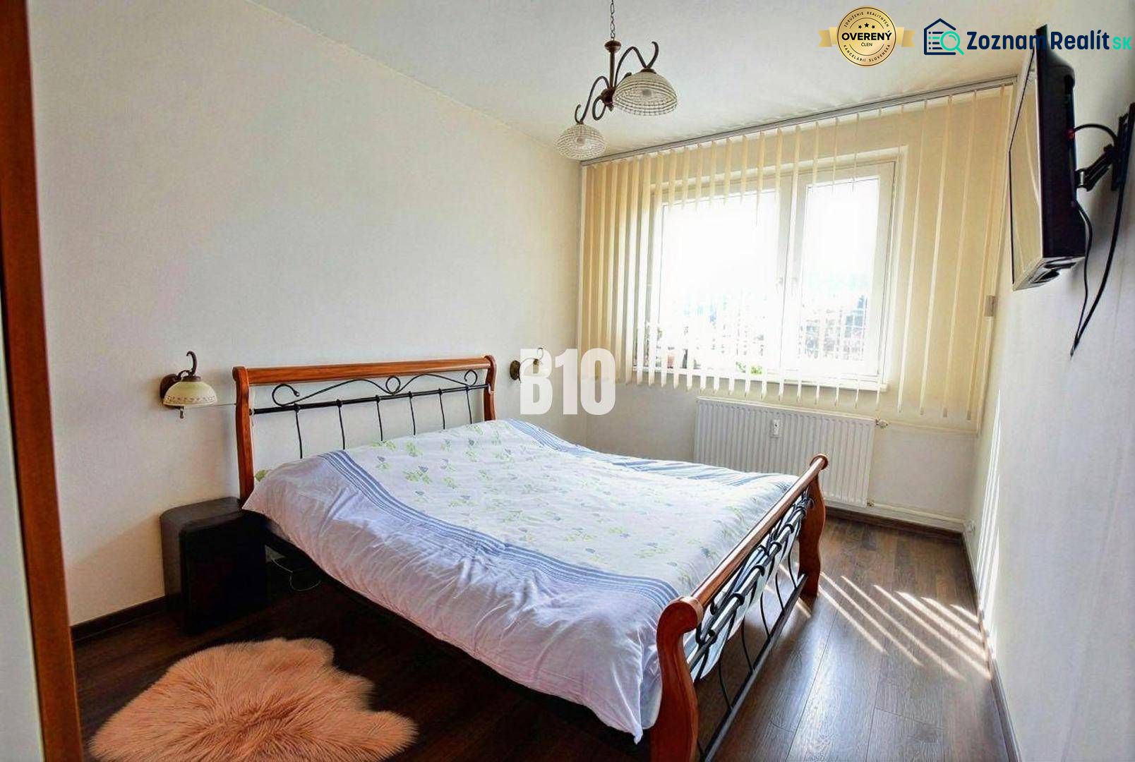 Bedroom with a double bed and a wooden decor floor, 3-room apartment.