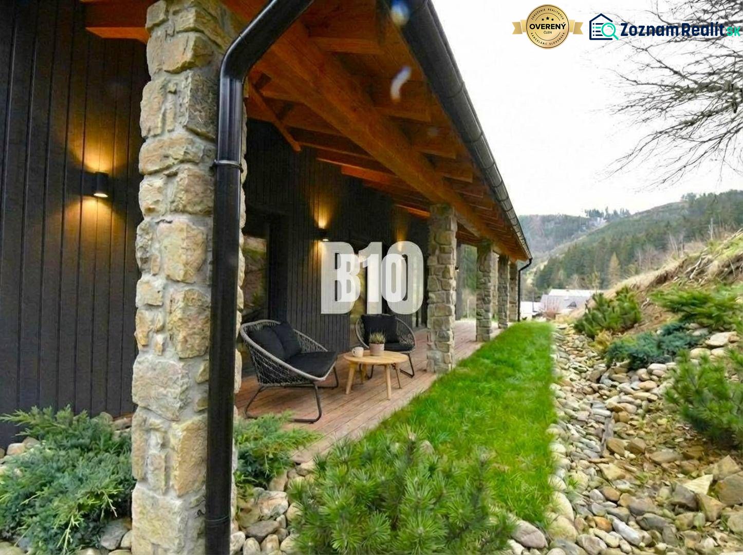 Covered terrace of the cottage in Horná Mariková with stone pillars and comfortable seating.