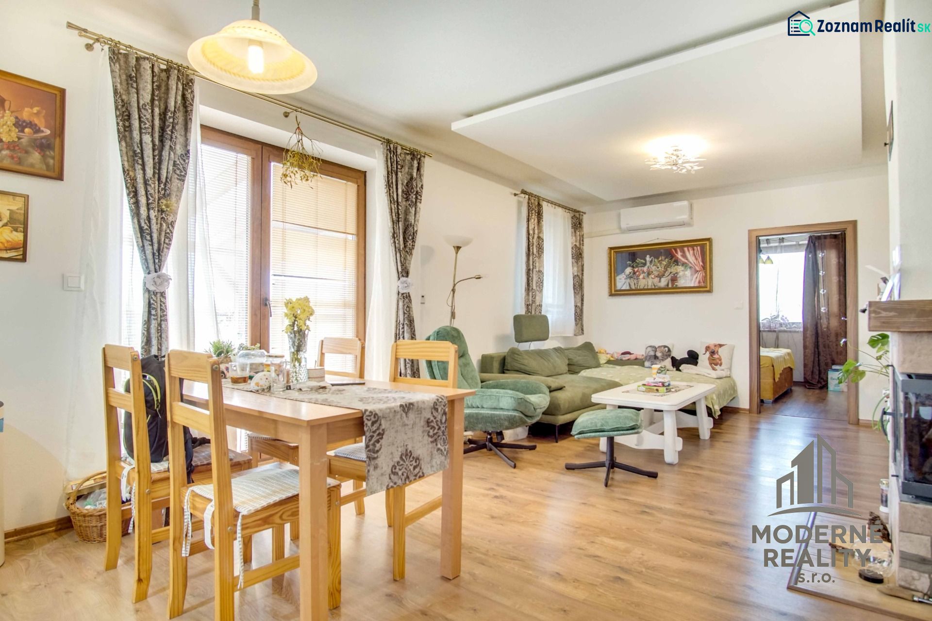 Dining room and living room with wood-patterned flooring in a family house.
