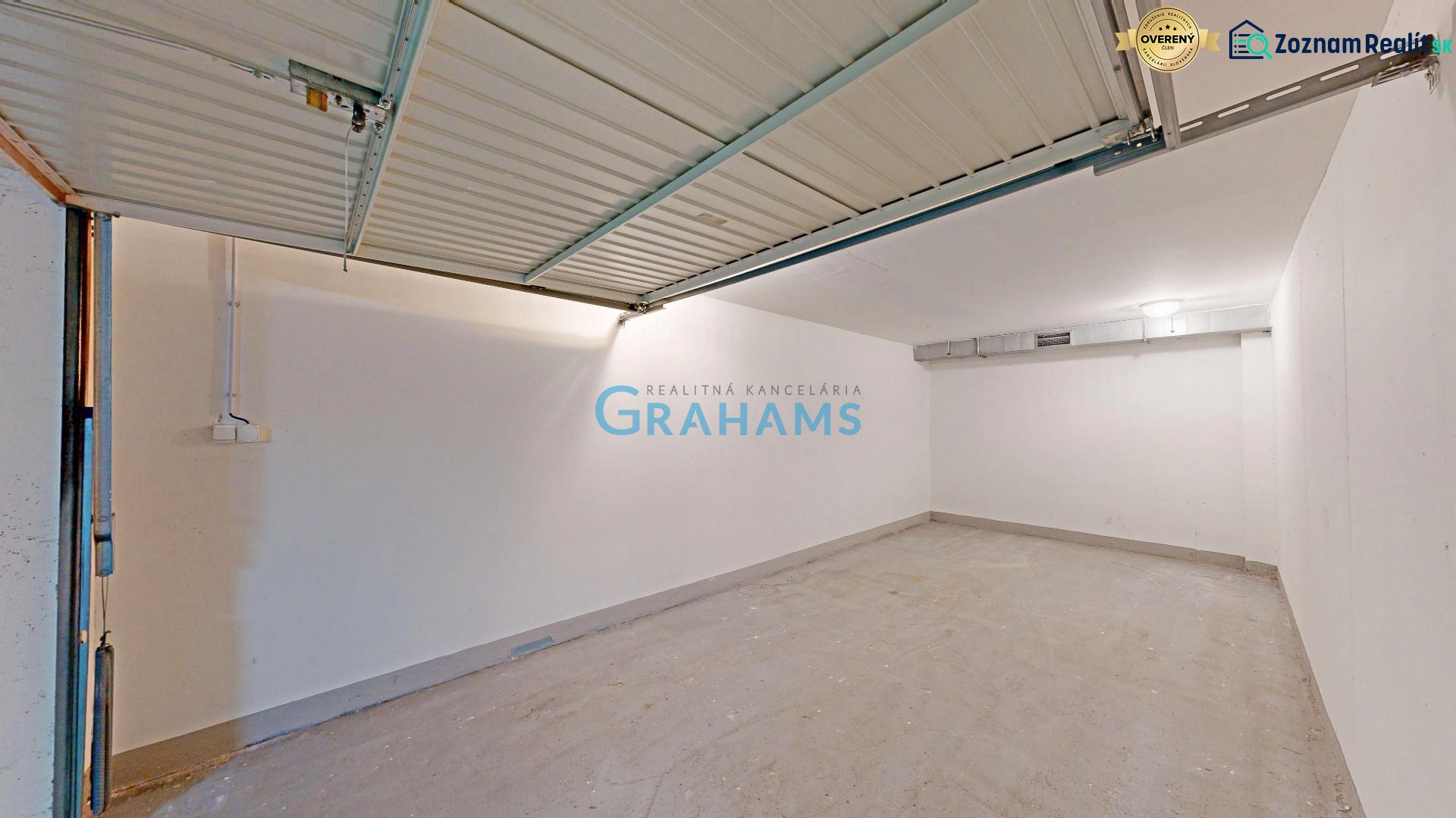 Garages with open doors, white walls, and concrete floor.