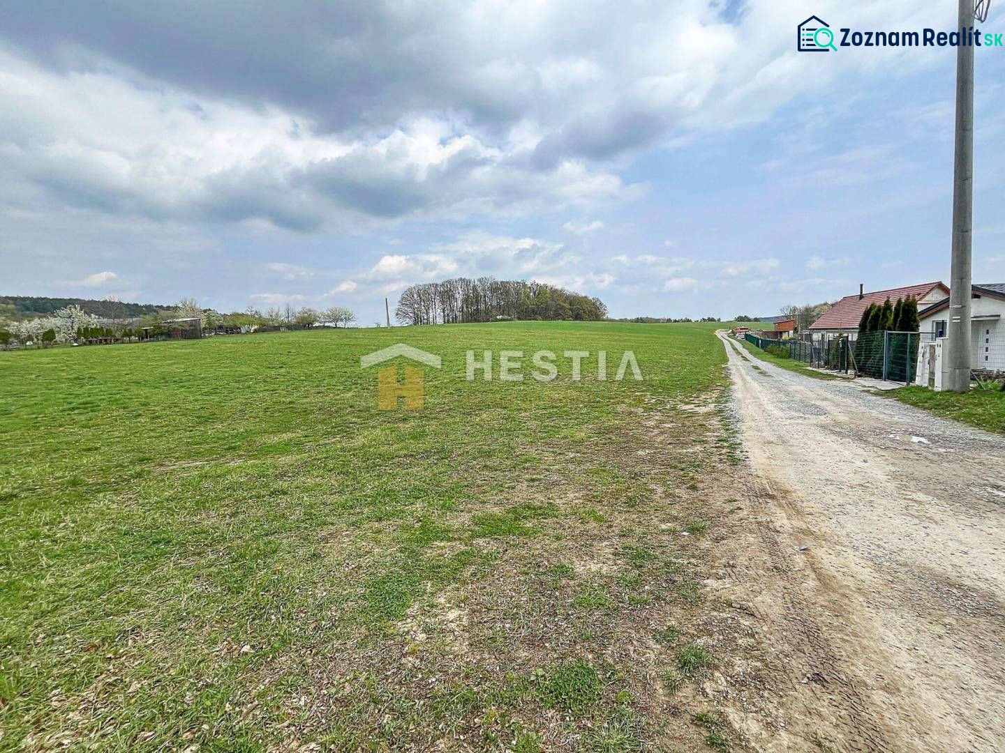 Extensive green plots suitable for living in the village of Bukovec under partly cloudy weather.