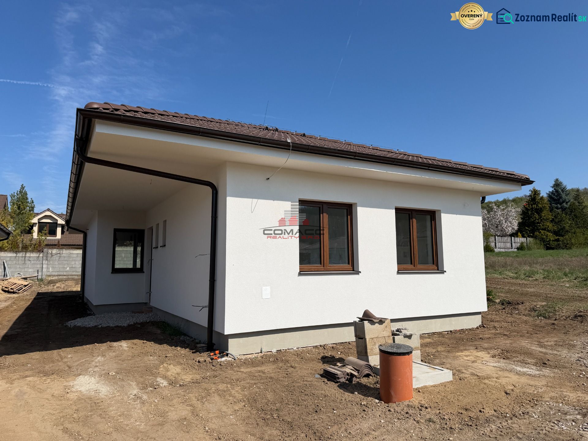 A family house on Pánska Niva in Hlohovec with a light facade and a brown roof.