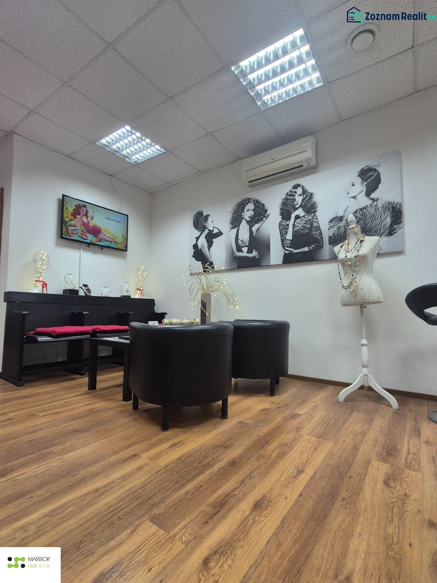 Interior of commercial spaces with wood-patterned flooring and artistic photographs.