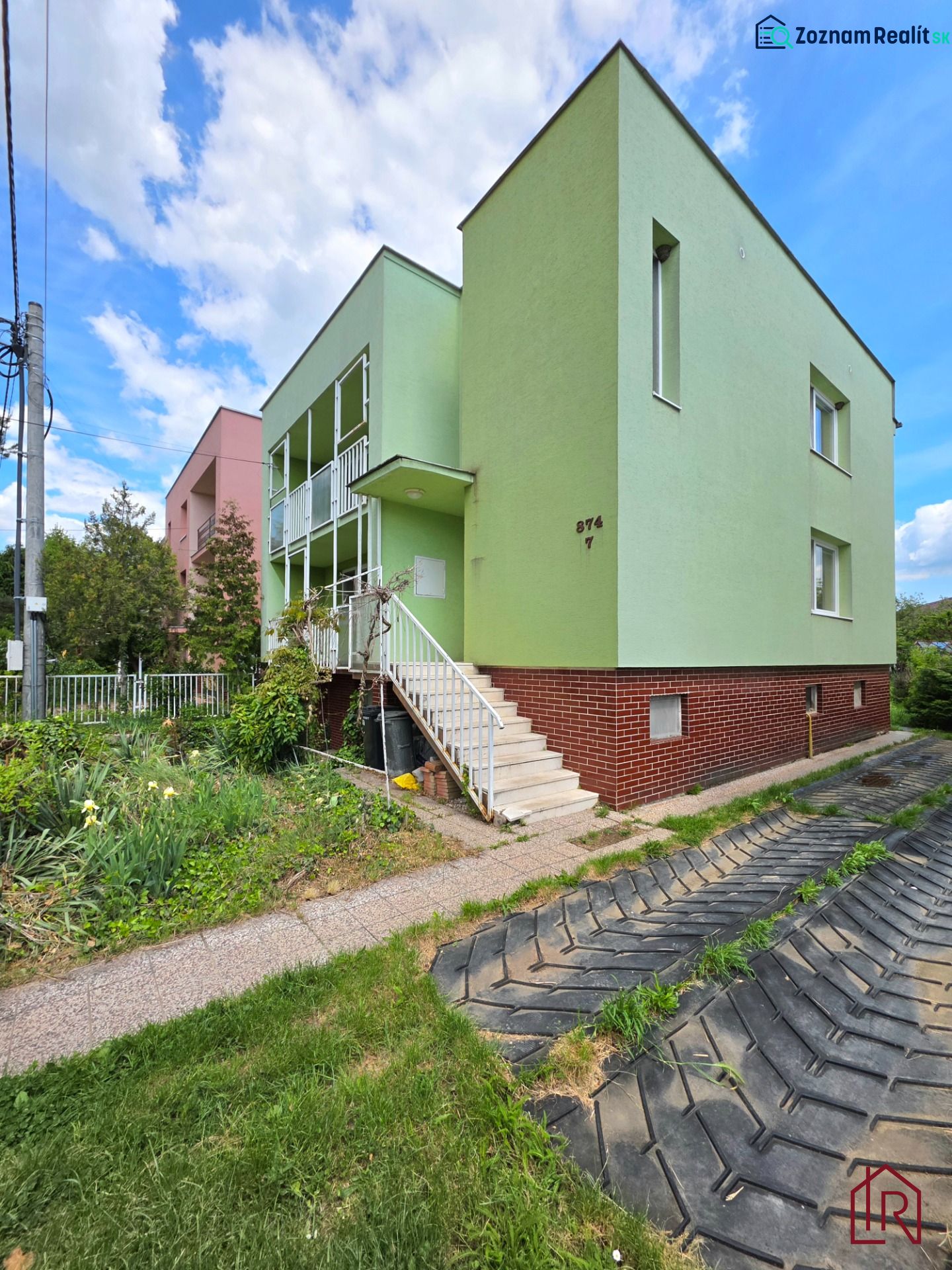A family house on Lesná Street in Čaňa with a green facade and a garden.