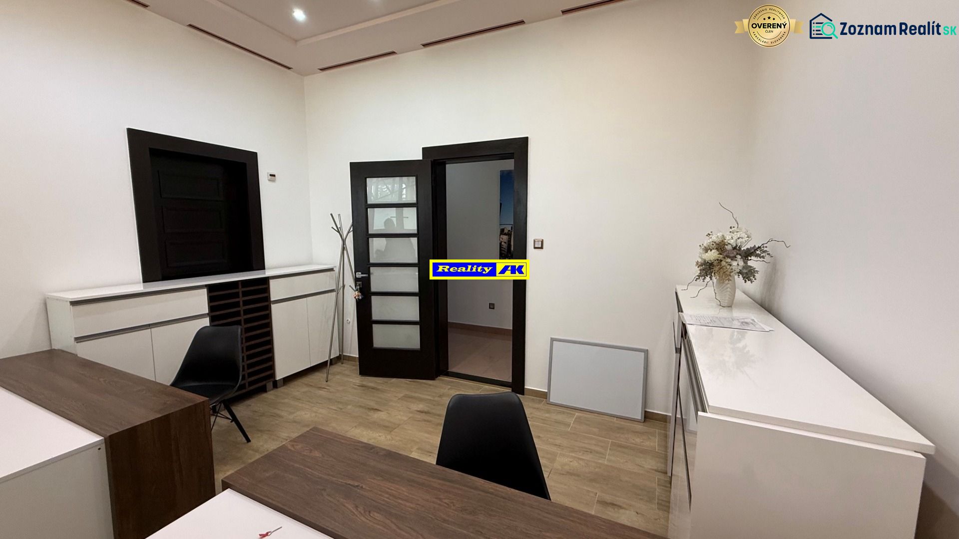 Interior of an office with wooden decor, modern furniture, and decorations on the desk.