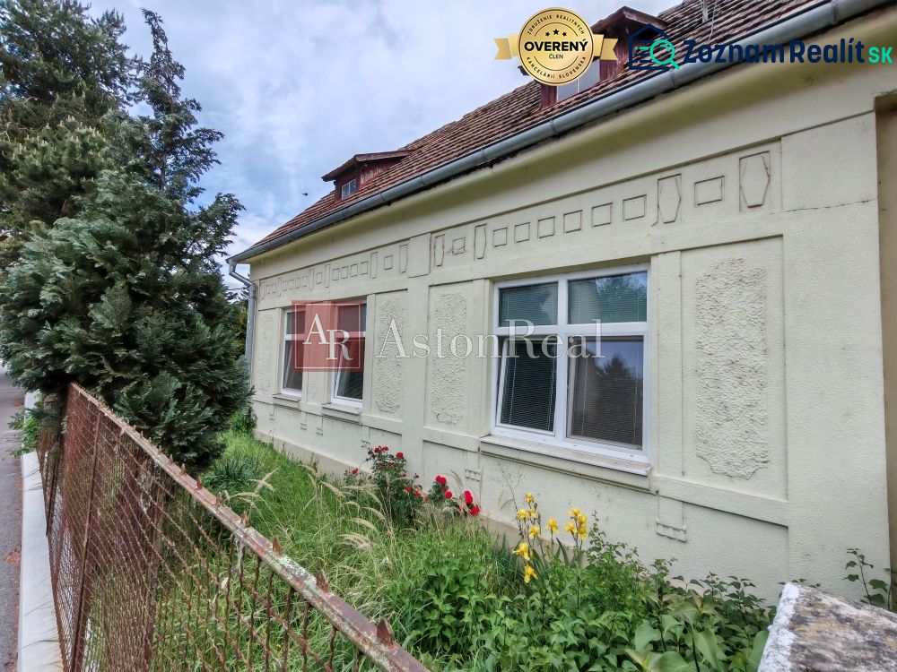 A family house on K Dolnej stanici Street in Trenčín, with a garden and fencing.