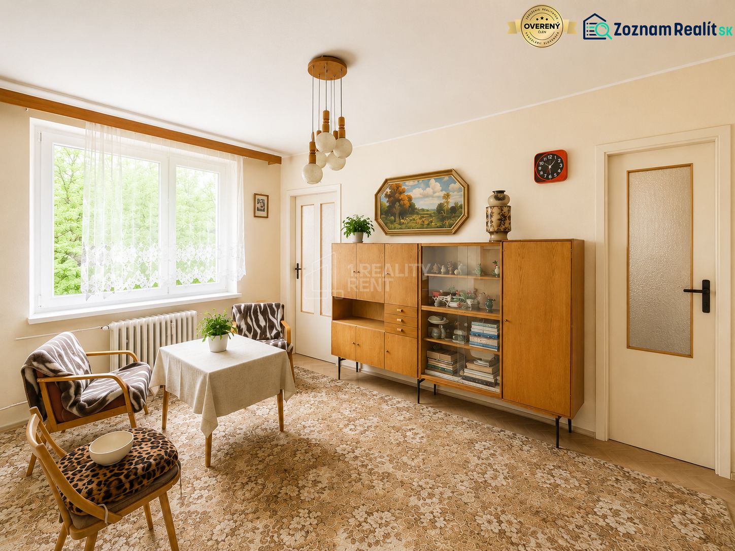 Living room in a 3-room apartment with retro furniture and a large window.