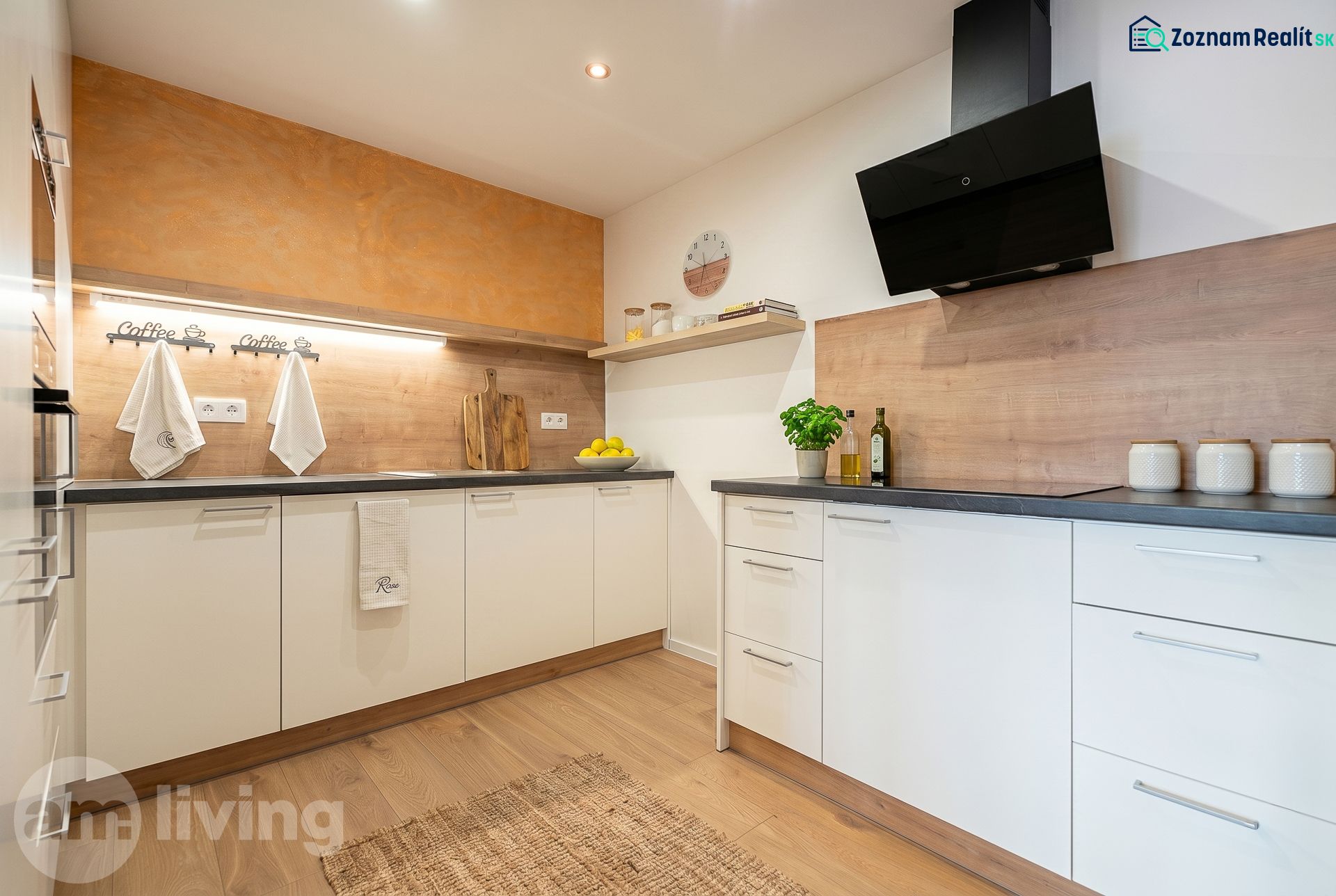 A kitchen in a family house with white cabinets, wooden decor, and citrus fruits on the shelf.