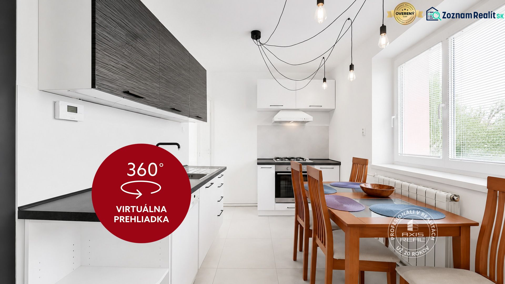 A kitchen in a 2-room apartment with a dining table and pendant lighting.