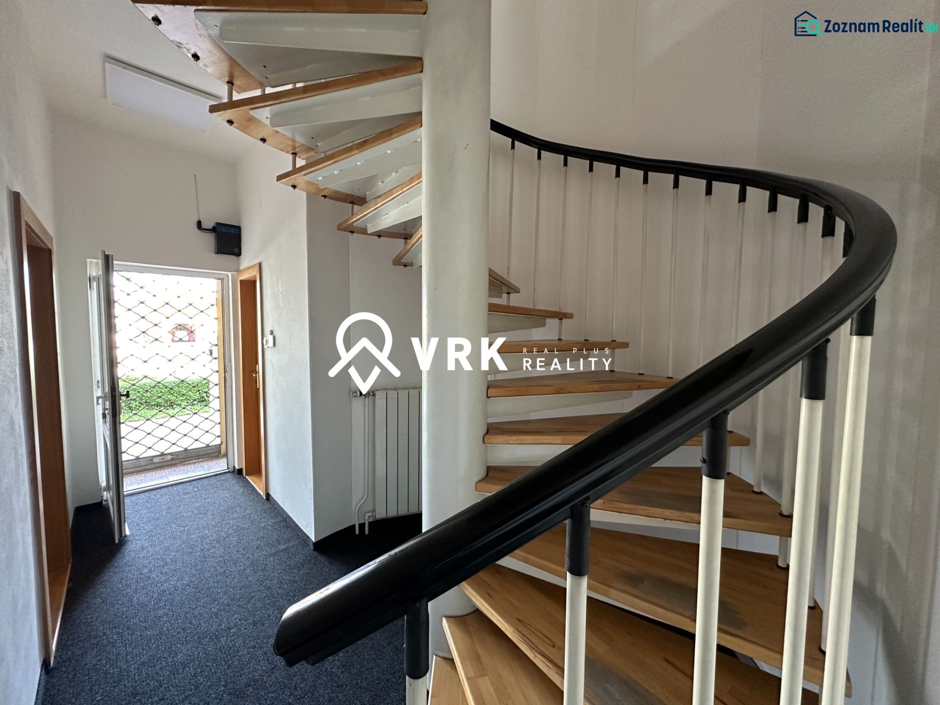 A spiral staircase with a wooden floor decor in offices.